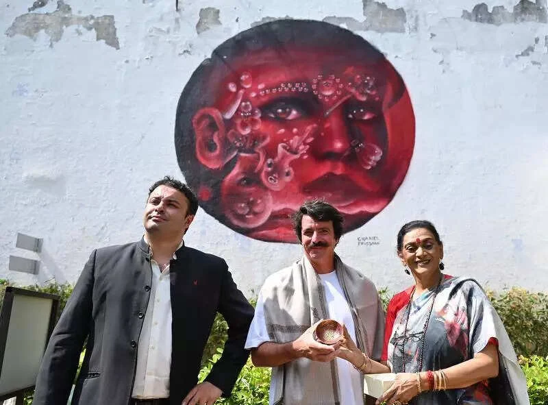 Charles Foussard’s red portrait mural at Le Press, pictured at its unveiling in 2024