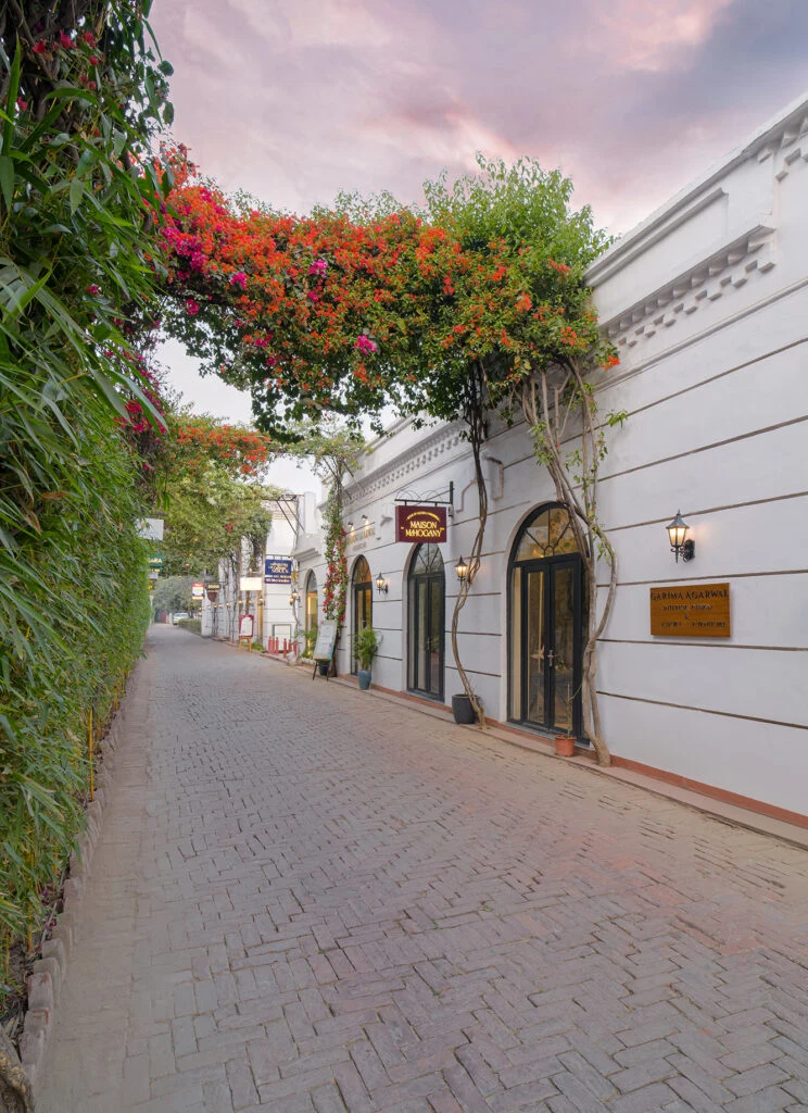 Hanging bougainvillea trellises above Le Press’s brick-paved walkway